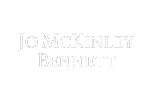 Jo McKinley Bennett in a beautiful classical serif font, written in white with a transparent background